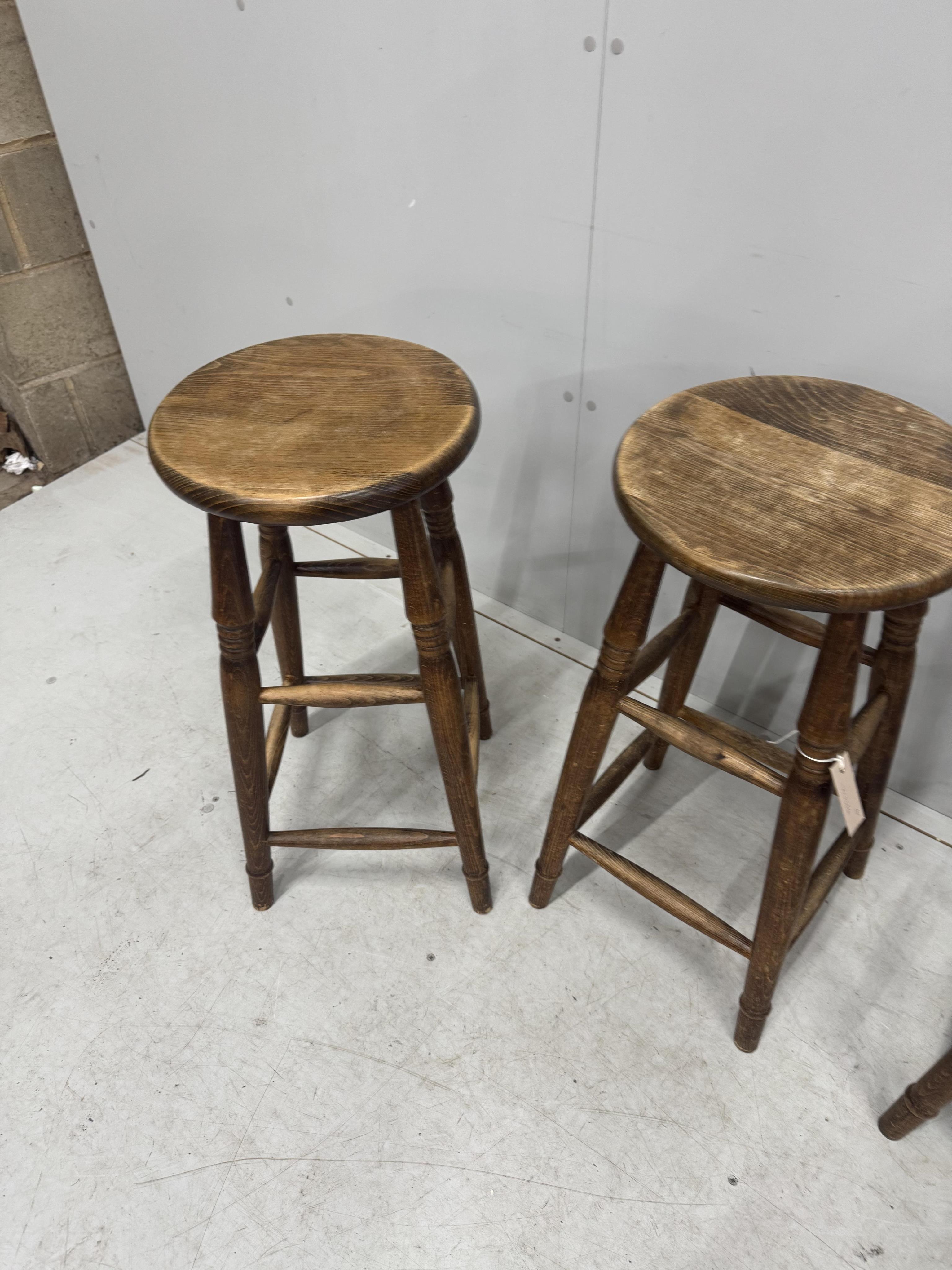 A set of four vintage beech bar stools, diameter 33cm, height 69cm. Condition - fair